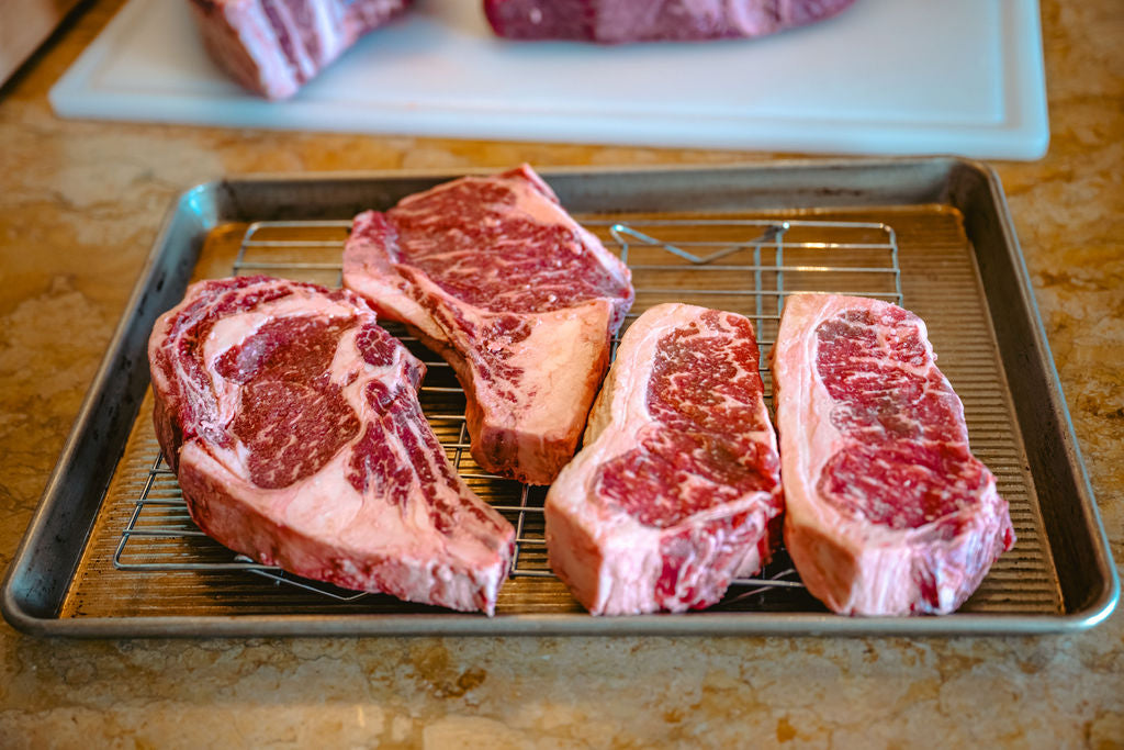 Premium dry-aged KC Strip steak from Brown Pearcy, grilled and sliced, part of our farm-raised Angus beef collection available for nationwide delivery