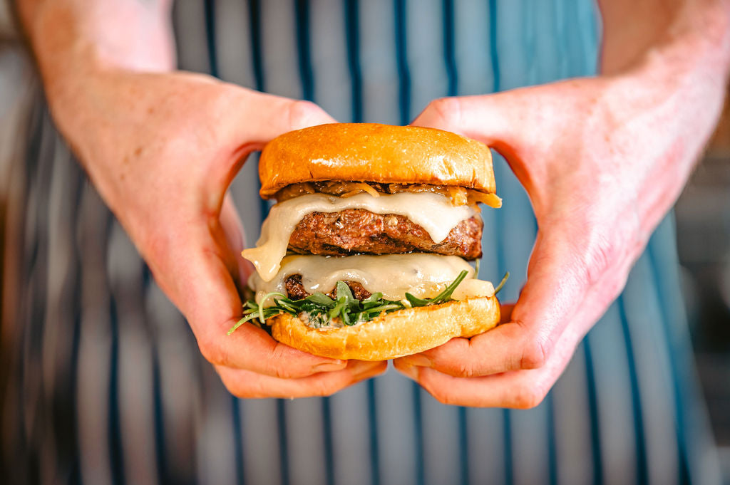 Juicy Angus beef burger grilled to perfection, made from pasture-raised, dry-aged beef for bold, natural flavor.