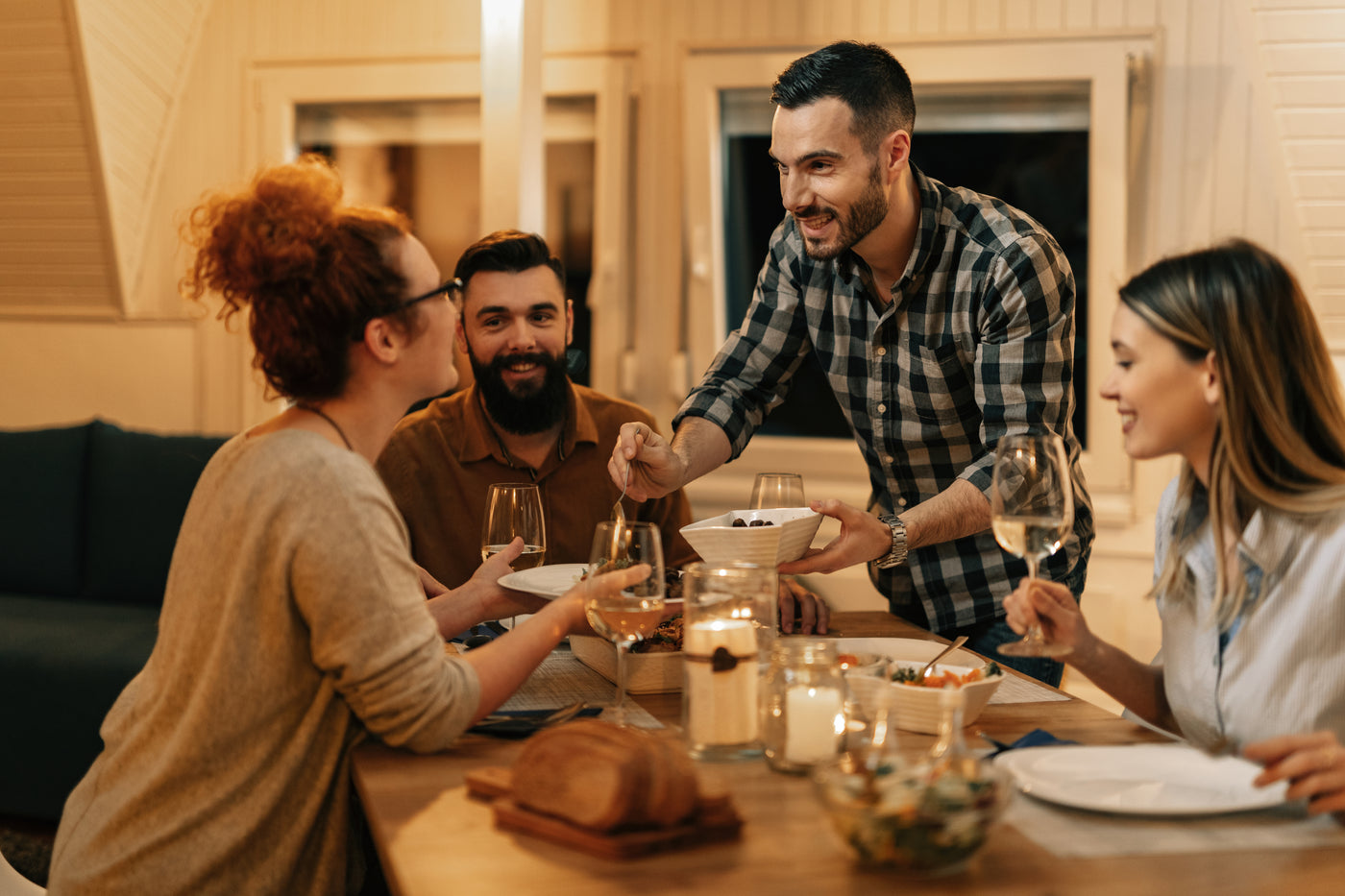 Group of friends enjoying a meal made with Brown Pearcy premium Angus beef and Berkshire pork, sharing farm-raised meat around the table in a casual, feel-good setting