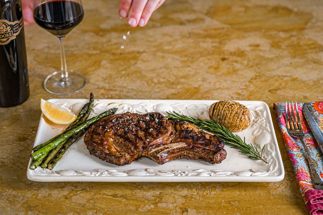 Cooked Angus beef steaks, pasture-raised and dry-aged, served on a dish with rich, savory flavor.