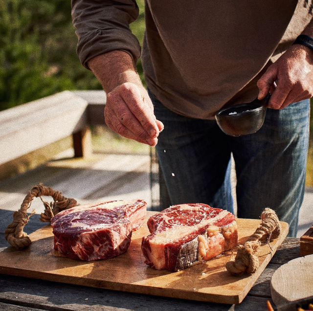 Grass-fed Angus steak sizzling on a cast iron skillet, seared to perfection