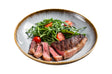Grilled top sirloin steak with char marks, sliced and served on a dinner plate with salad